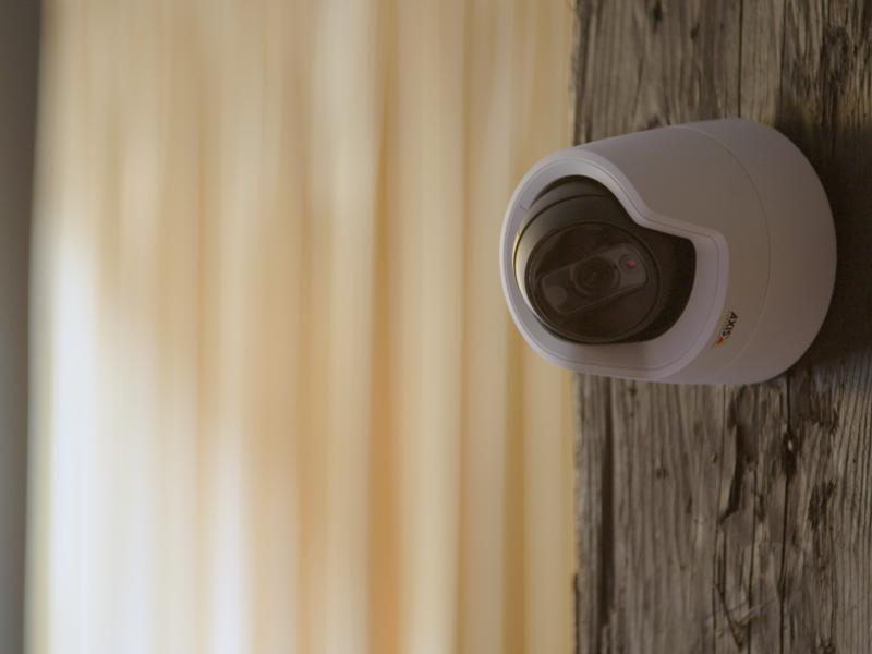 AXIS M3115-LVE IP Camera mounted on wooden pillar in an indoor environment
