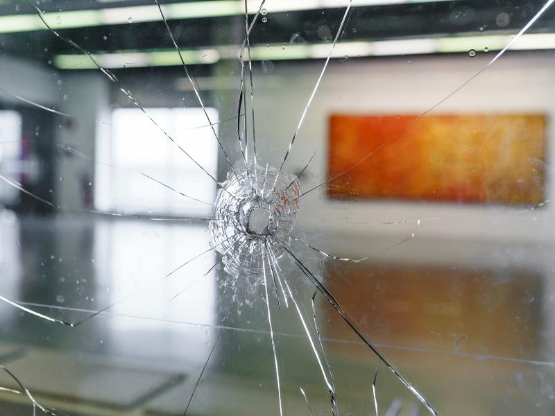 Broken window with bullethole