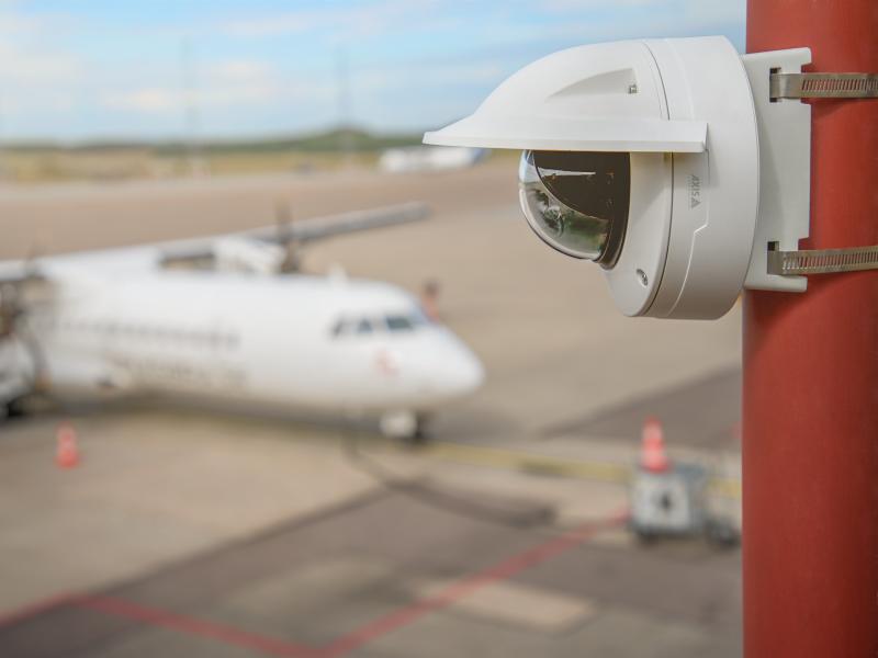 AXIS Q35 network camera mounted on a pole, airplane in the background