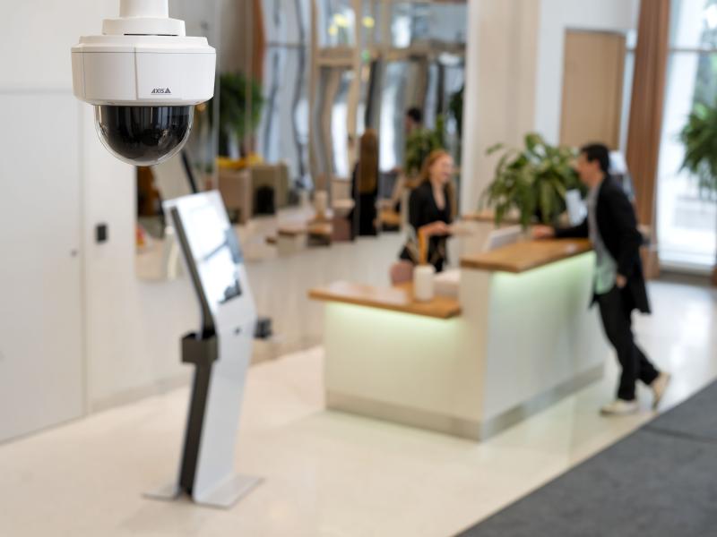 AXIS M5526-E PTZ Camera hanging from roof in a hotel lobby
