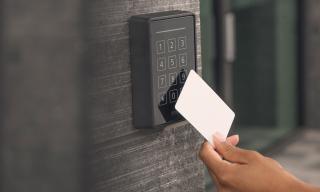 access control, hand holding a card to enter the door