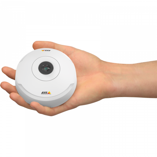 Human hand holding round AXIS camera.