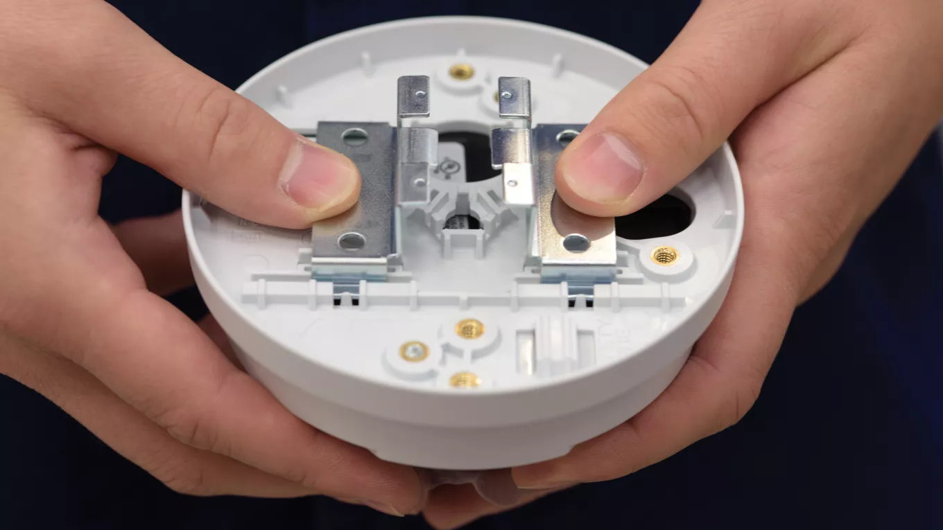 AXIS T91A23 mounting accessory closeup with hands