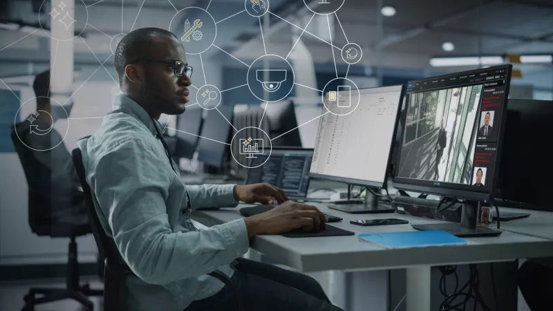Man in front of monitor showing AXIS Secure Entry interface