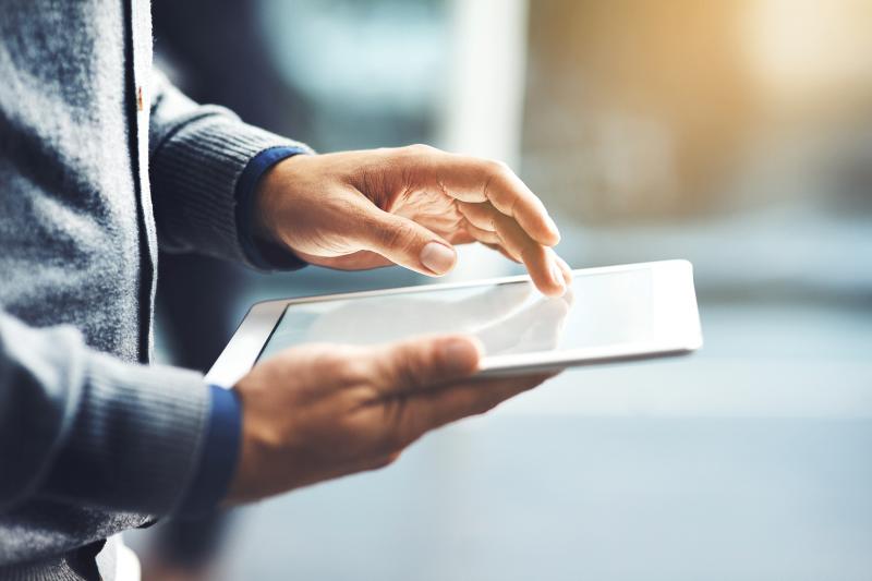 hands holding tablet