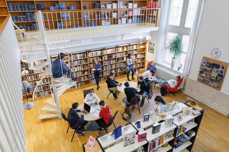 An overview of some kids sitting in a school library