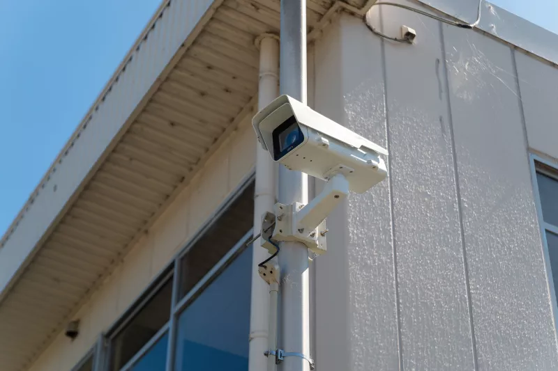 Axis P1365-E Mk II placed on a building, viewed from its left side.