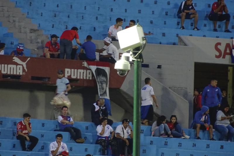 Stadium with blue seats and Axis Camera on a pole.