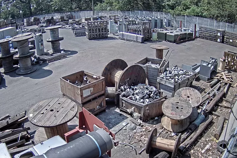 Yard with electric cables, wooden pallets and more.