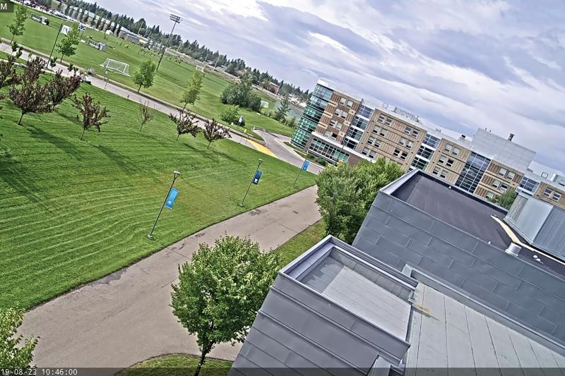 Exterior of campus viewed above from tilted angle, green grass outside.