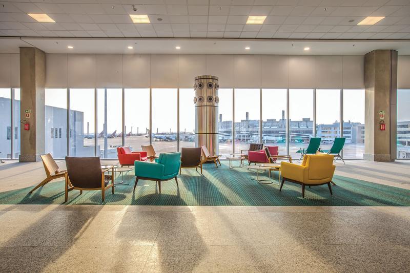 Gate waiting area viewing airplanes outside.