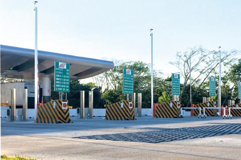 Toll booths for cars, green instruction signs.