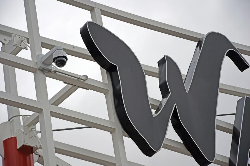 Axis camera in outdoor environment next to a black W.