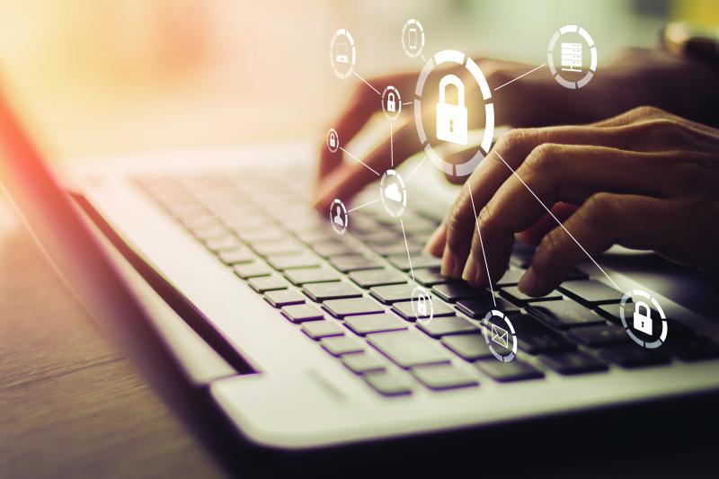 fingers that is typing on a keyboard, padlocks in light color in the foreground