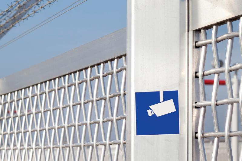 Metal fence with blue sky behind
