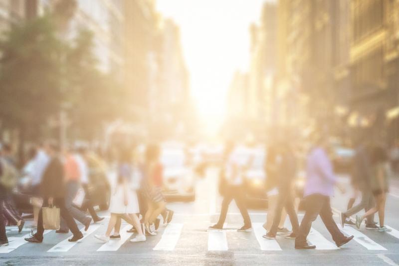 Blurry picture of people crossing crosswalk in a city