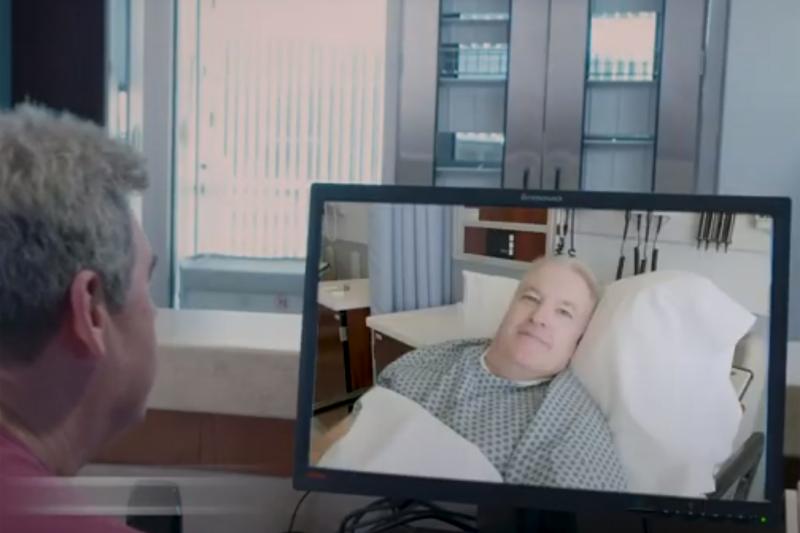 A patient and a realtive have a virtual visit using screens
