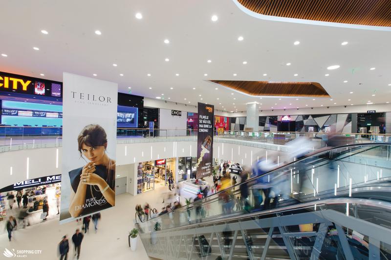 Escalator and entrances to shops in city mall