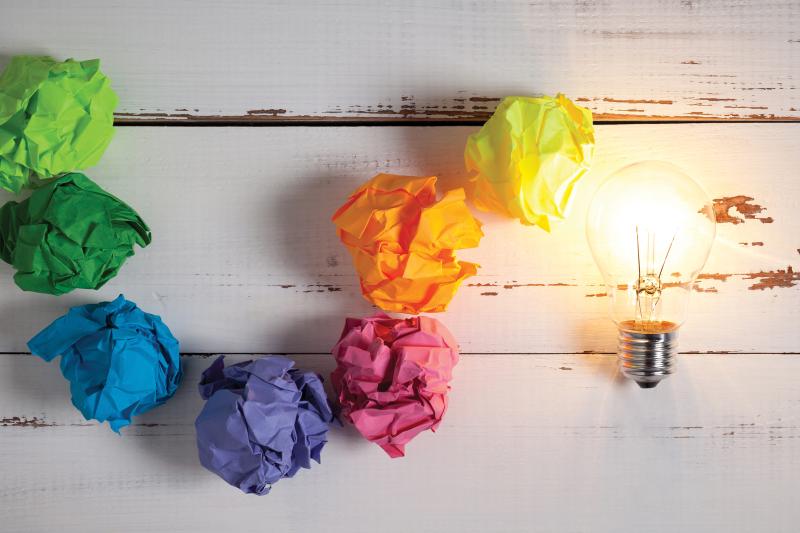 Lightbulb of crumpled paper in rainbow colors.