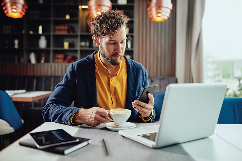 man with laptop at a coffee shop