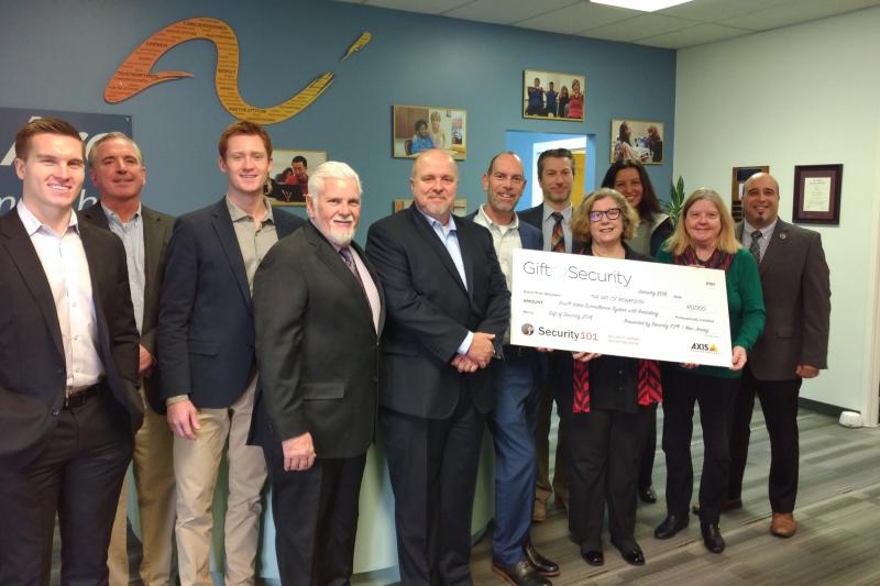 Group of people holding large check for Arc of Monmouth