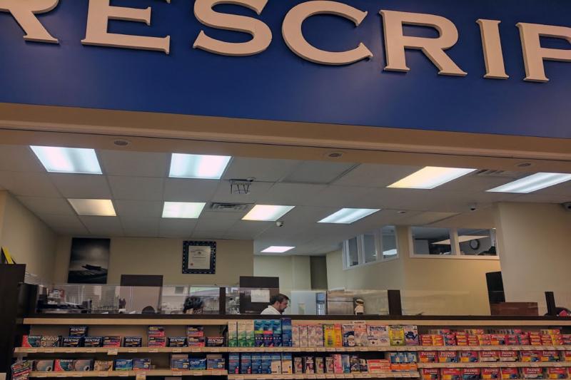 Photo of pharmacy desk with technician