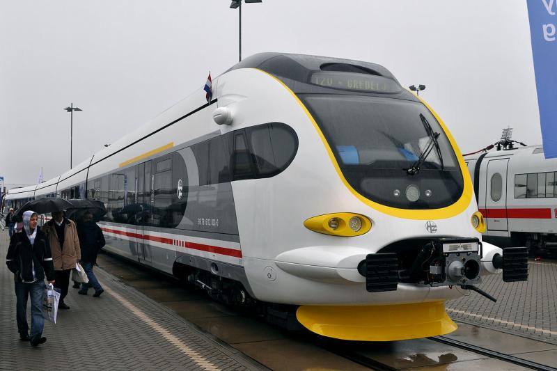 Modern train at platform with people