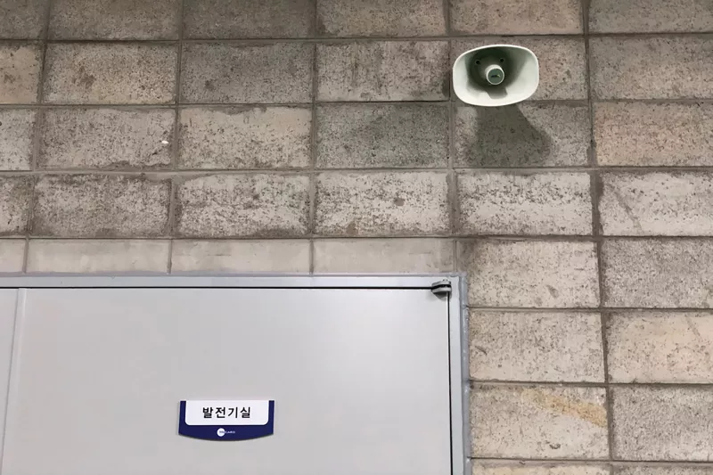 Speaker on grey brick wall