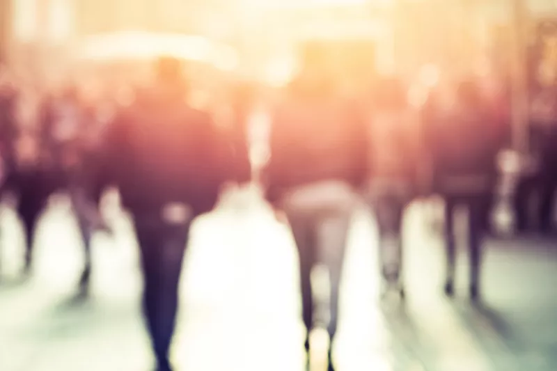 people walking in sunset light