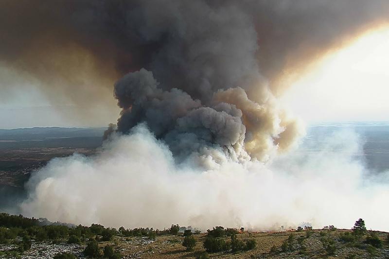 Smoke cloud over green landscape