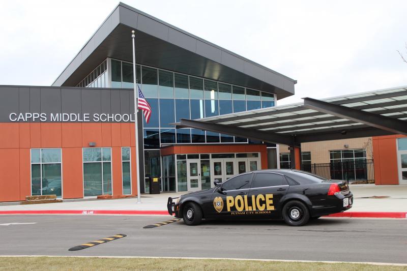 Exterior of Putnam City School District middle school with police cruiser in front