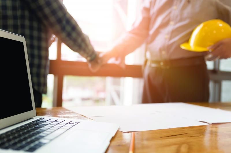 two people shaking hands, blurry background