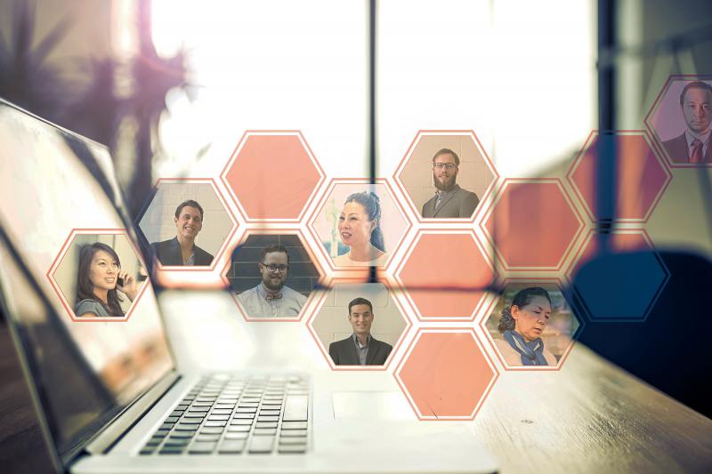 Hexagons with peoples faces floating above laptop