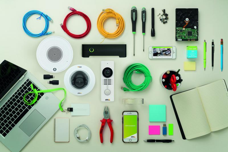 Table with organized items. cords, computer, camera, notebook and tools