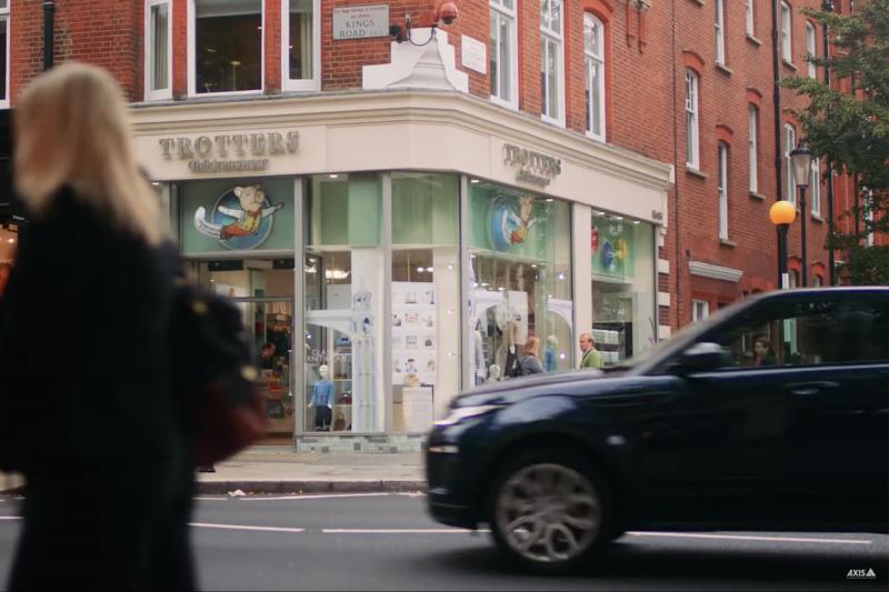 Store front at Totters, black car and person dressed in black walking past