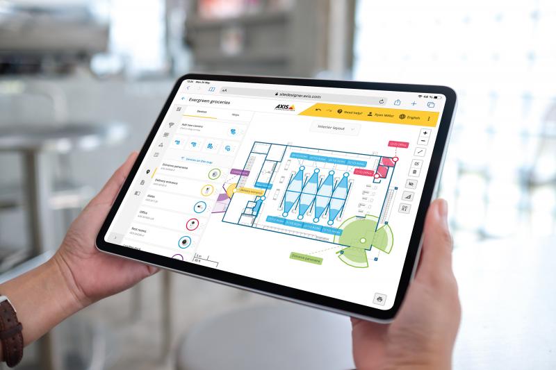 Hands holding a tablet with site designer on