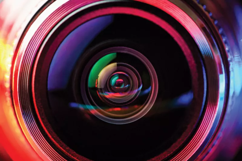 A closeup of a camera lens in multicolor