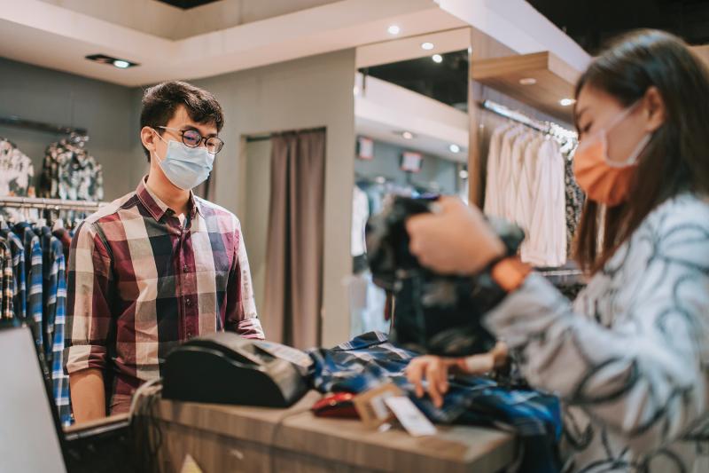 cashier helping customer in a clothing store