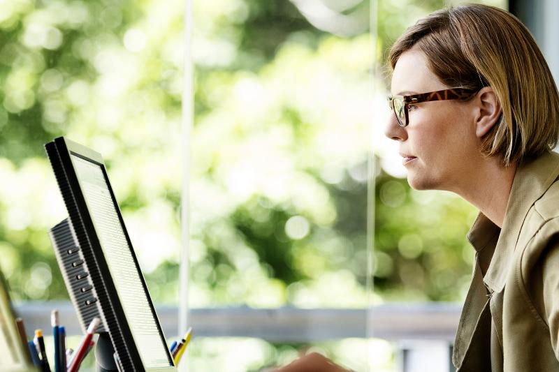 woman sitting in front of a computer screen