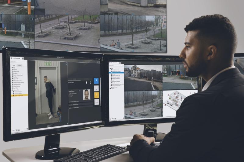 Man working by two computer screens