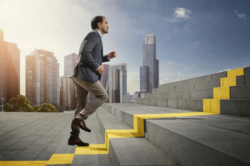 Person running up stairs, reaching new heights