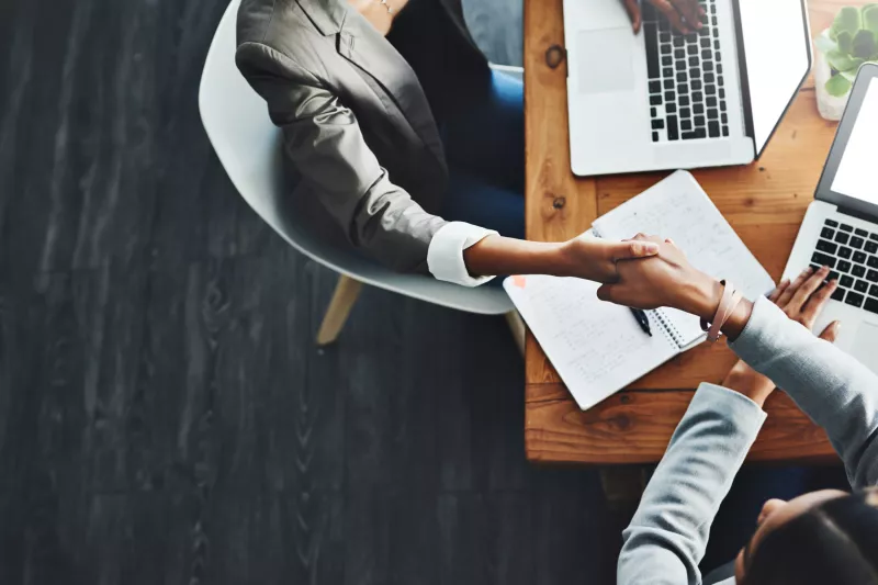 High angle two businesswomen shaking hands office 2301 hi