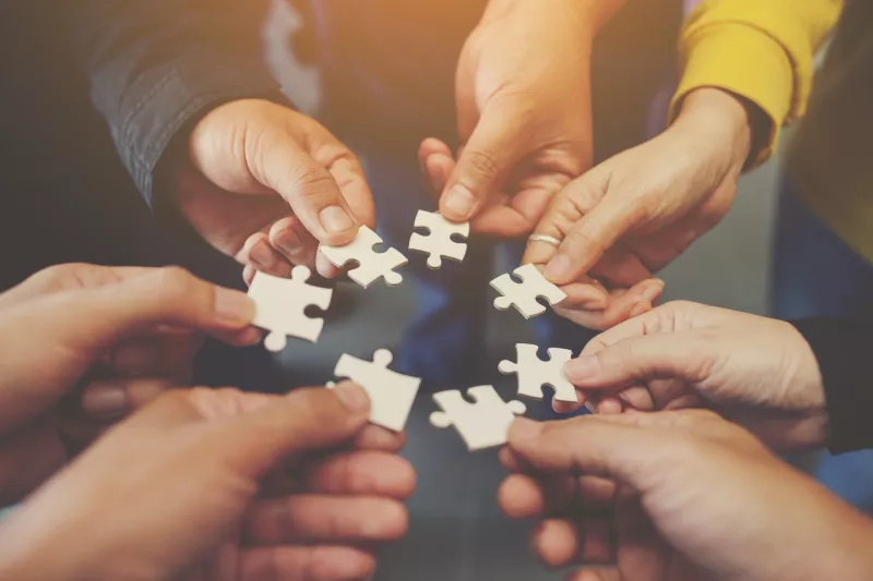 Hands circle jigsaw puzzle pieces