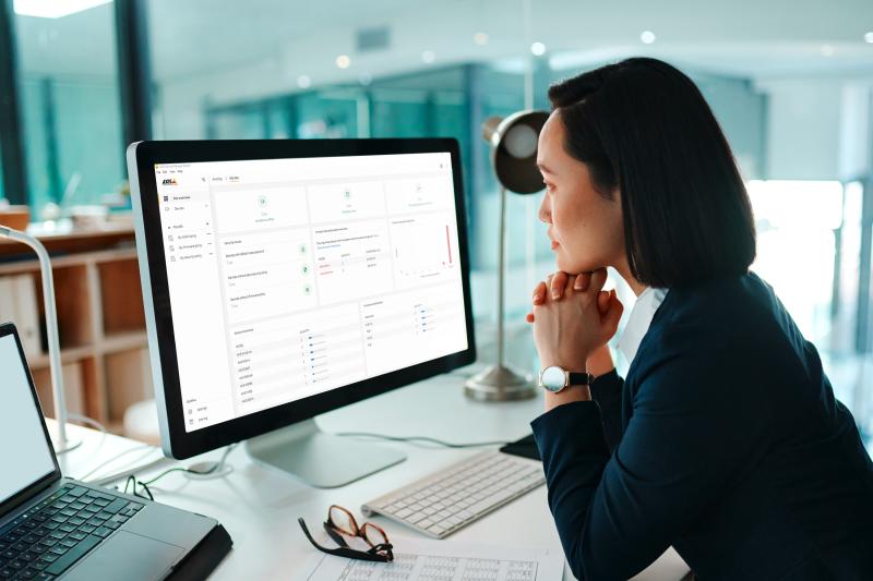 woman looking at screen with axis device manager extend interface