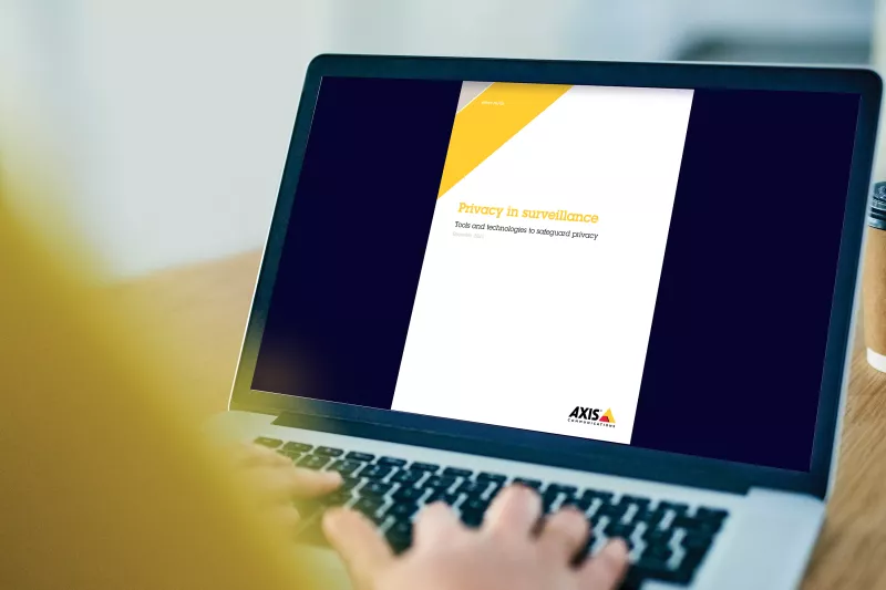 laptop with whitepaper on screen and hands