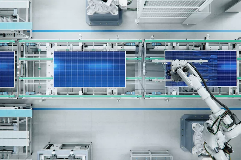 robots working at manufacturing line with solar panels
