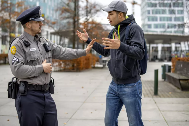 Police officer calming agitated man