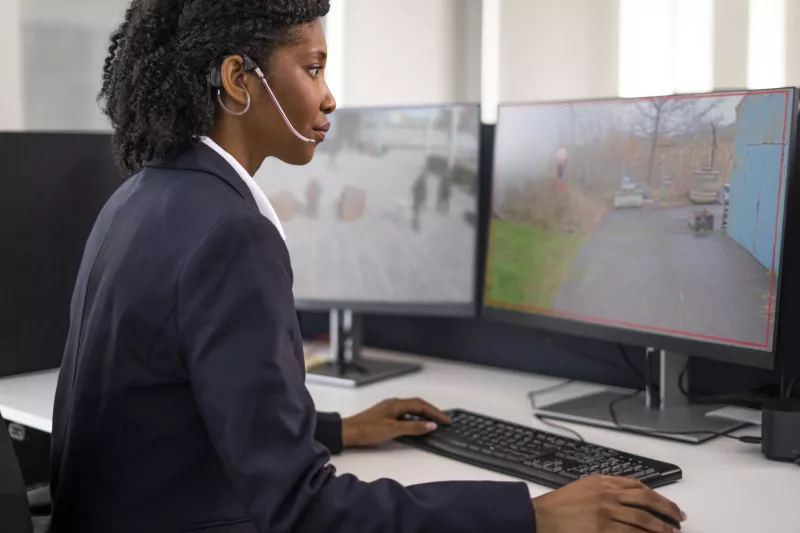 woman with headset working in front of computer
