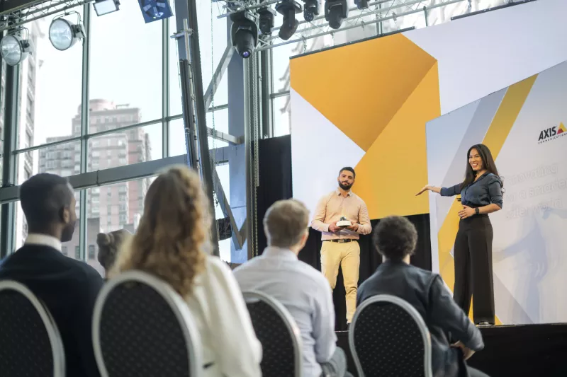 TIP woman and man presenting on stage at event
