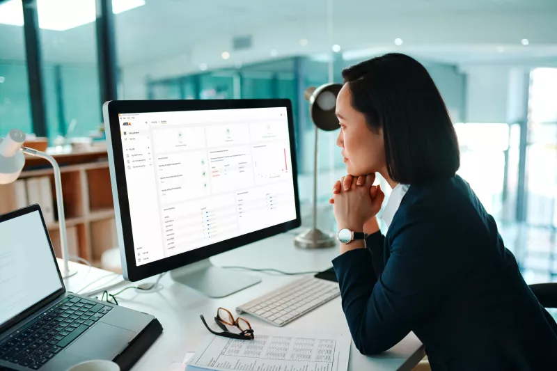 Business woman looking at a desktop computer in an office